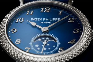 Patek Philippe’s Ref. 7121/200G features a white gold case set with diamonds on a blue sunburst dial, with white gold moons and stars accompanied by a small seconds display.